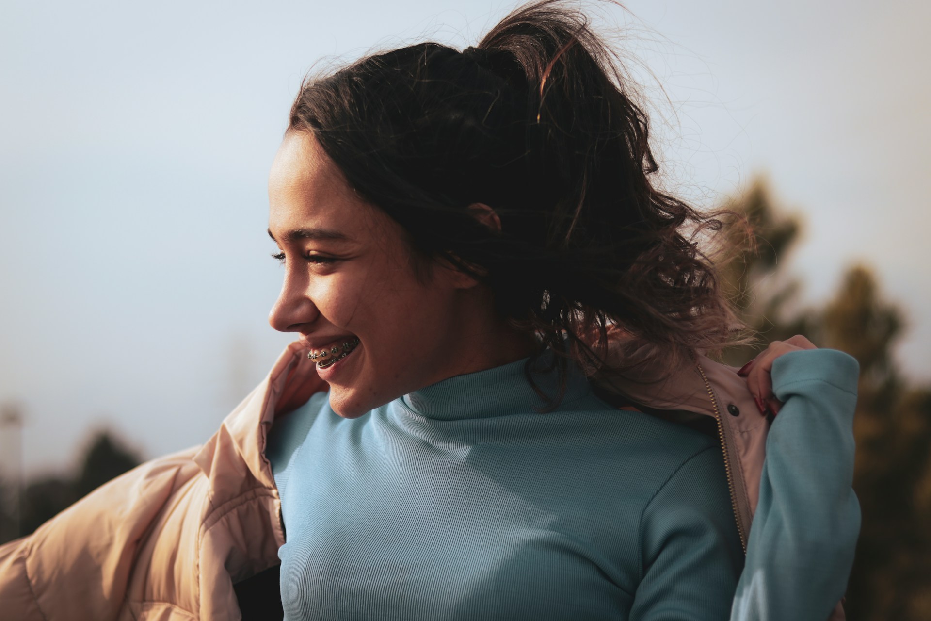 A smiling young woman with braces