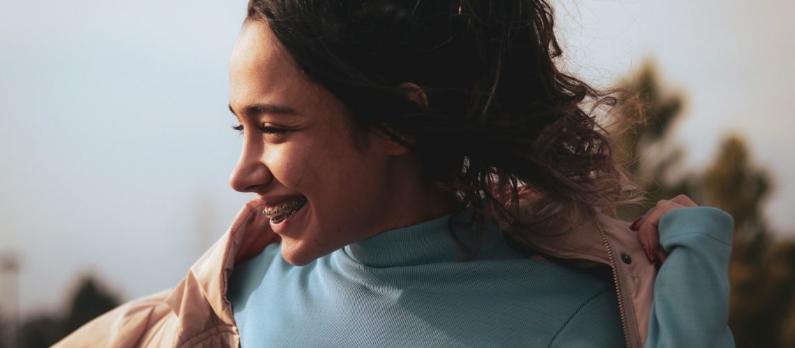 A smiling young woman with braces